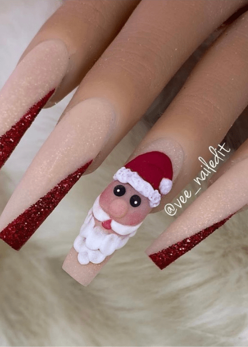 Sparkly Christmas nail design with a acrylic design of Santa Clause