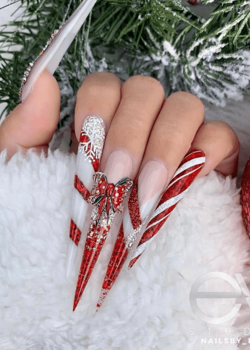 Long red and white stiletto Christmas nails with a bow
