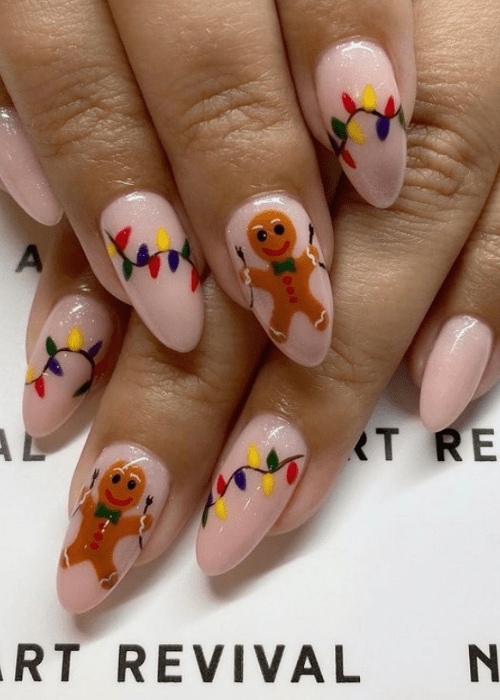 Christmas nail design with a gingerbread man holding Christmas lights