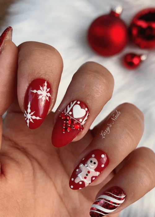 Red and white Christmas nail design with snowflakes and a gingerbread man