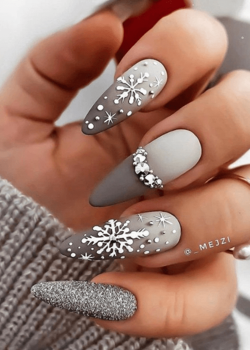 Grey Christmas nail design with snowflakes and rhinestones