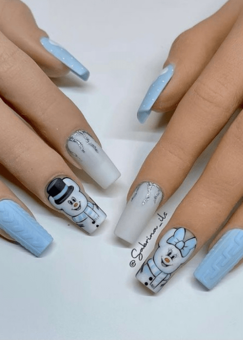Light blue and white winter nail design with a snowman and a snowwoman
