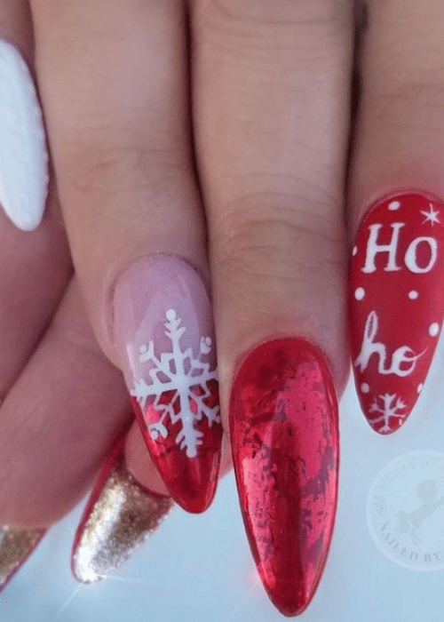 Red and white Christmas nail design with gold under the nail and that says ho ho