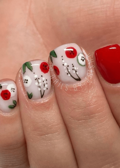 Christmas nail art with red white and green flowers