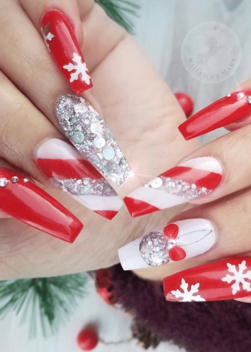 Red and white Christmas nail design with sparkles and rhinestones and snowflakes