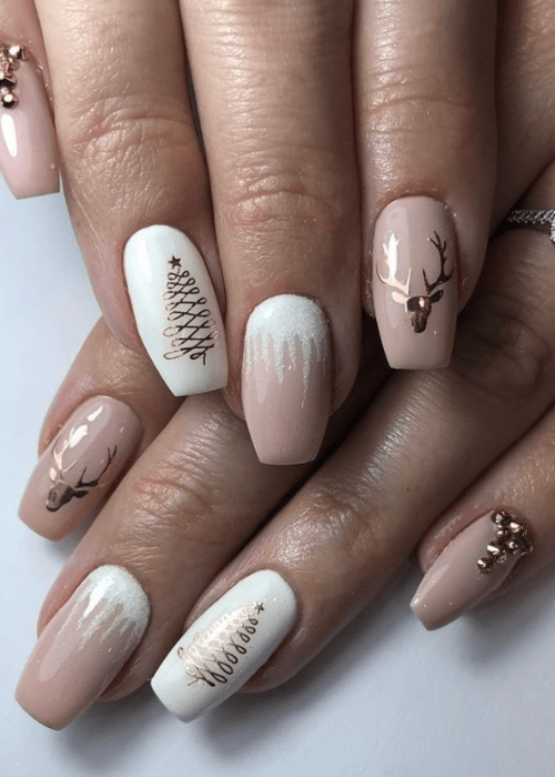 Pink white and gold Christmas nail design with a Christmas tree and a reindeer