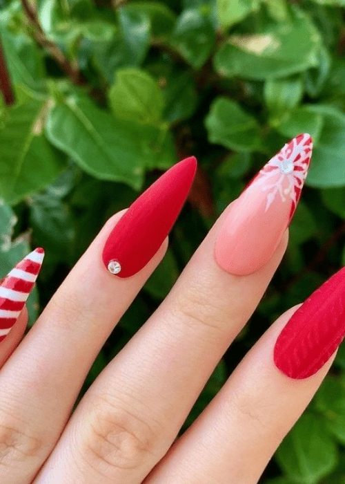 Red and pink Christmas nail design with a snowflake