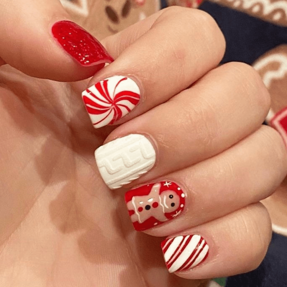 Christmas nail design with a gingerbread man and candy cane designs