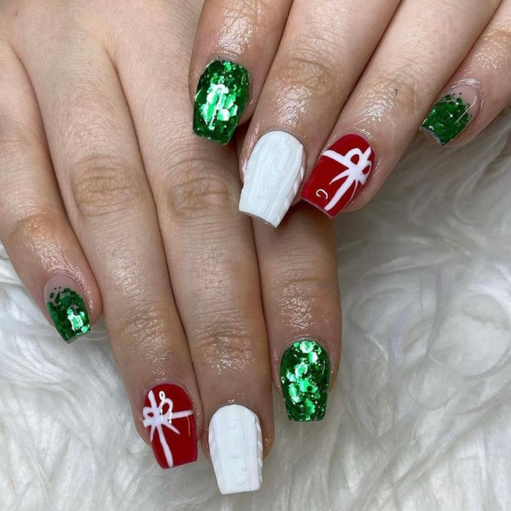 Green red and white nails with a present design