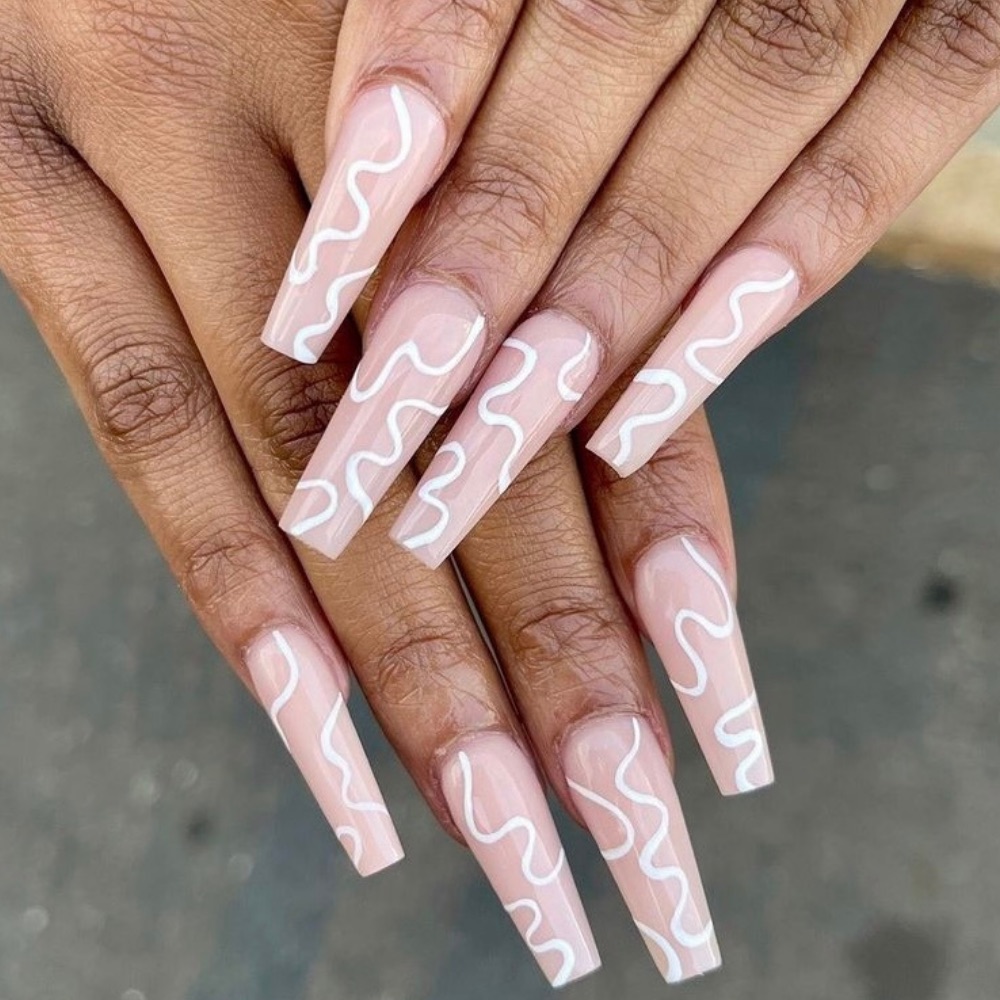 Long pink acrylic nails with simple white wavy lines
