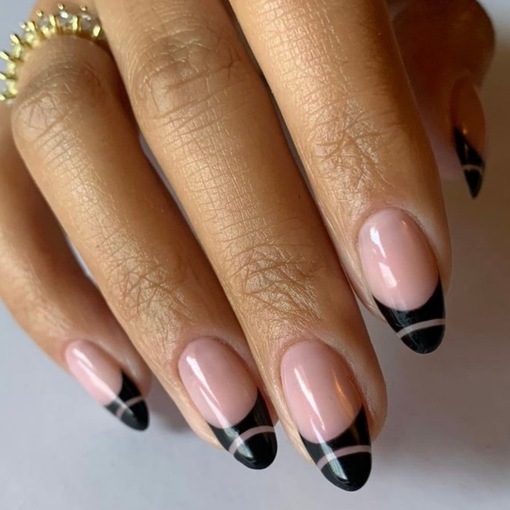Almond shaped nails with a black French Tip and negative space
