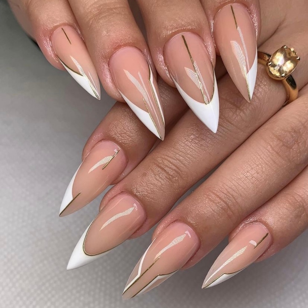 Acrylic stilleto nails with a white French tip and gold line