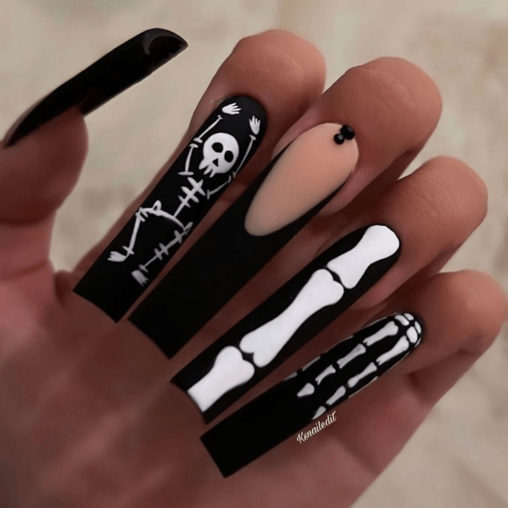 Halloween nail design on long nails with designs of bones