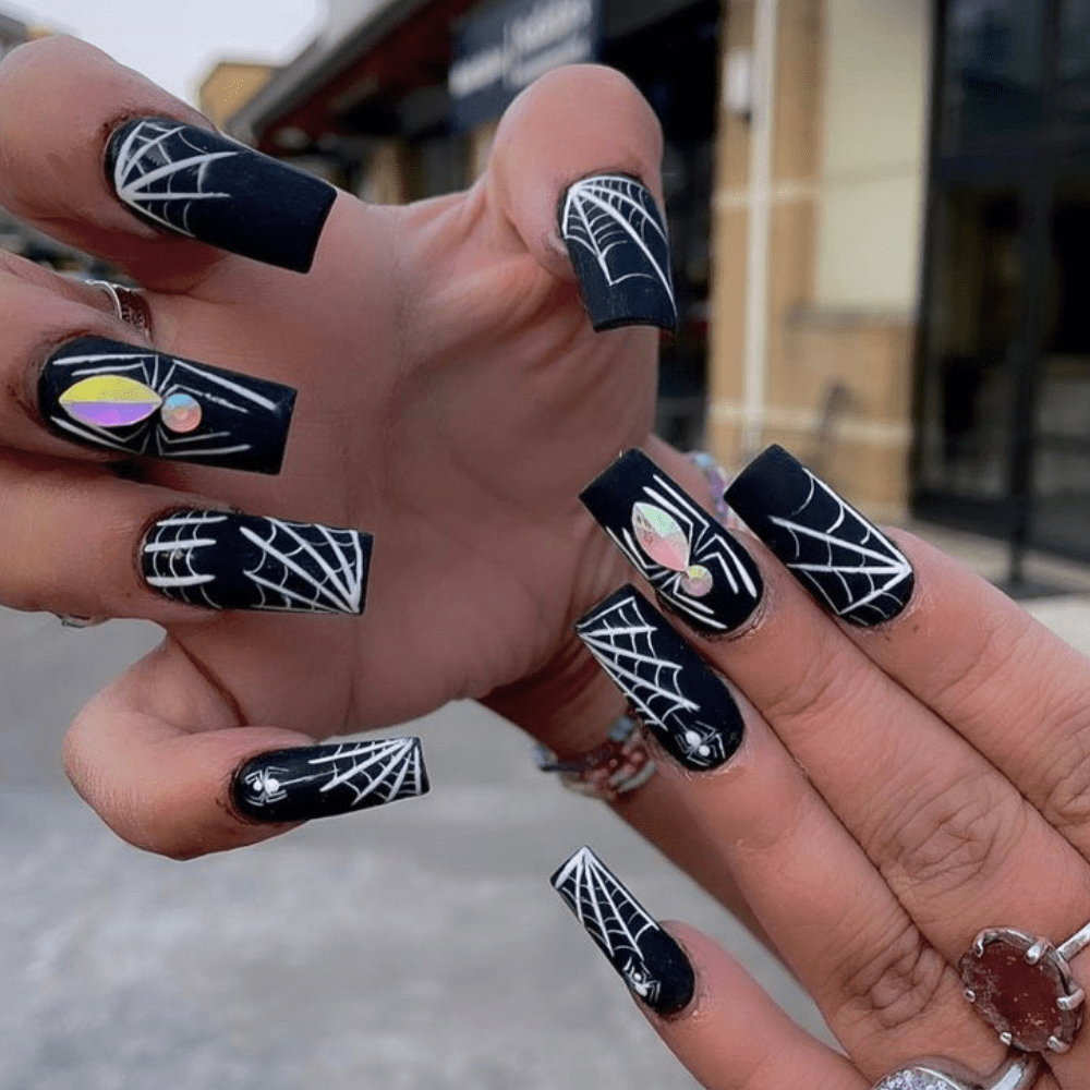 Nail design with spiderwebs and spiders