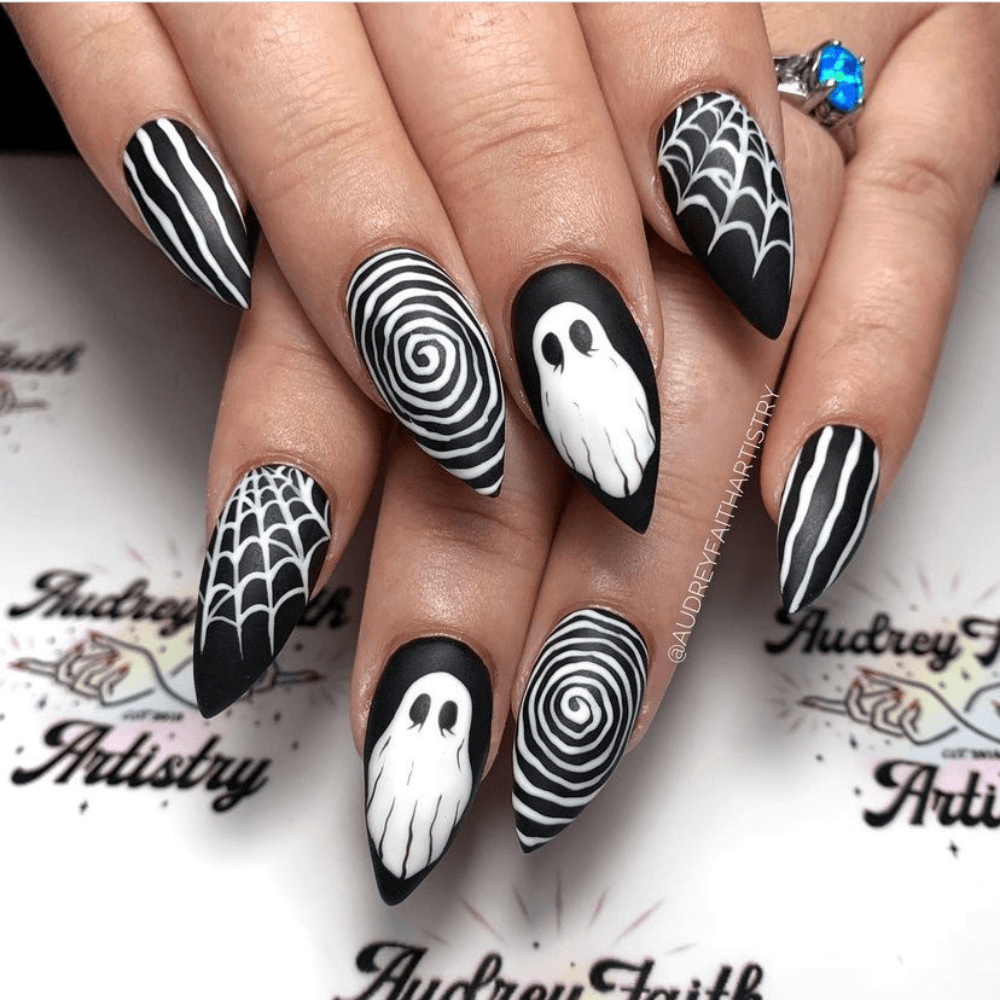 Black and white halloween nail design with spiderwebs and ghosts